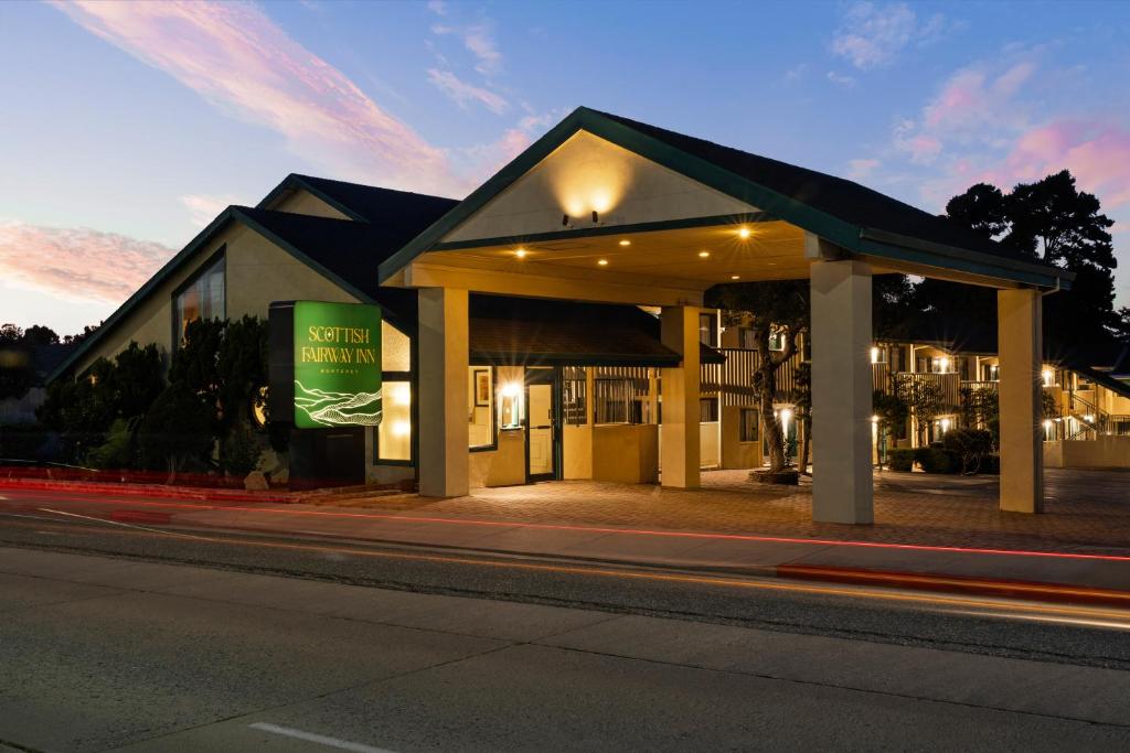 a building on the side of a street at night at Scottish Fairway Inn in Monterey