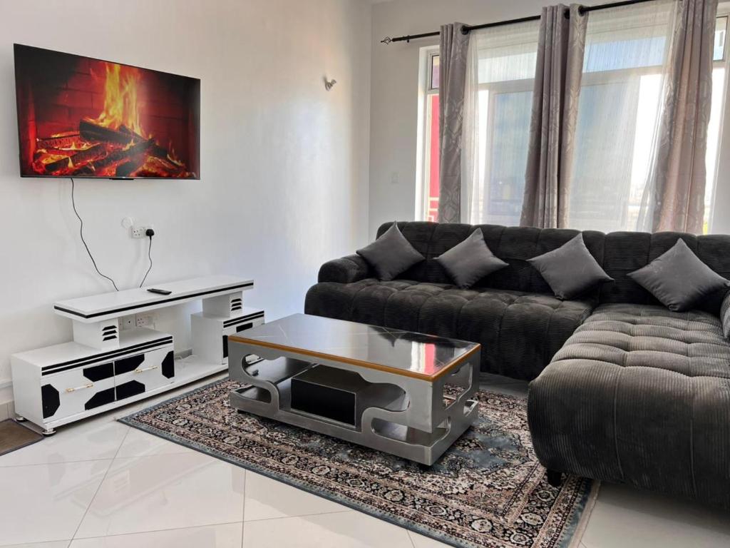 a living room with a couch and a coffee table at Blossom Homes A2 in Mombasa