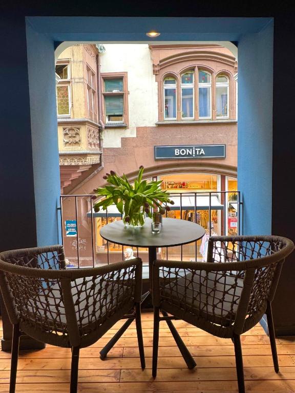 a table and two chairs in front of a store at AltstadtOase in Konstanz