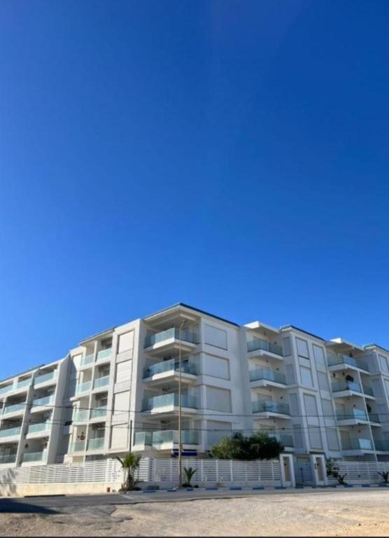 a large white apartment building on the beach at Studio Hergla in Sidi Bou Ali