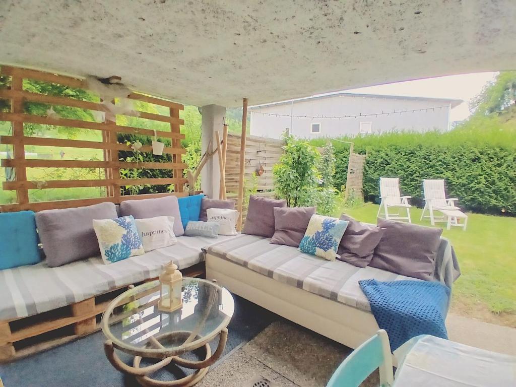 a living room with a couch and a glass table at Lotus Oasis I Nature Experience in Torre