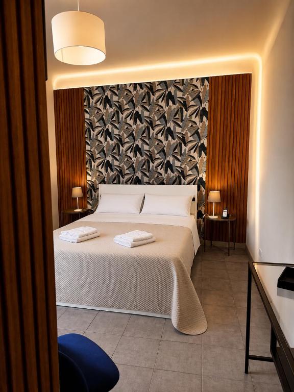 a bedroom with a bed with two towels on it at B&B Sicily O'Clock Room in Lentini