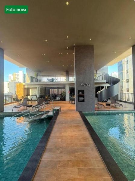a large building with a pool in the middle of it at Ancorar Hospedagens in João Pessoa