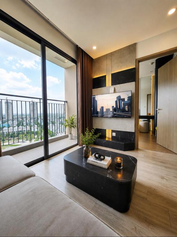 a living room with a bed and a large window at Ocean Nest - 2BR Apartment in Ocean Park in Gia Lâm Pho