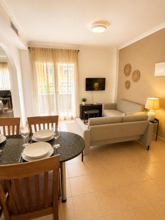 a living room with a couch and a table at Casa Azul, with a shared pool in Baños y Mendigo