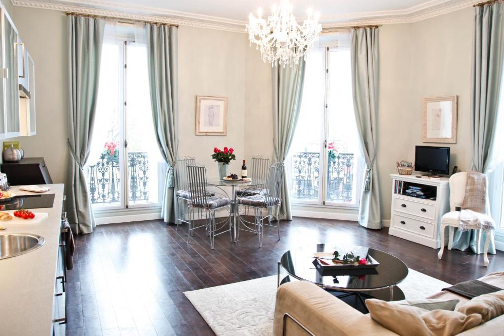 a living room with a couch and a table at La Charme Du Marais in Paris