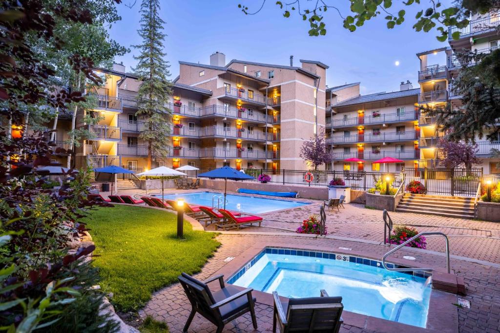 a hotel with a swimming pool in front of a building at Vantage Point in Vail