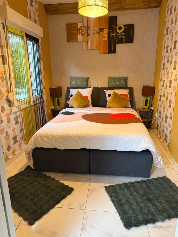 a bedroom with a large bed with two rugs at Sirine57 Charming House for 5 Guests Large Private Parking for Cars Vans in Florange