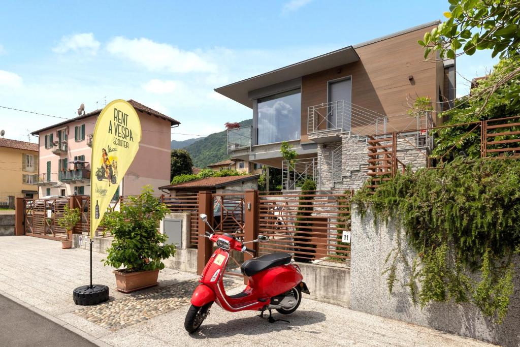 a red scooter parked in front of a house at La Casetta di Cannero by Residenza La Zagara in Cannero Riviera