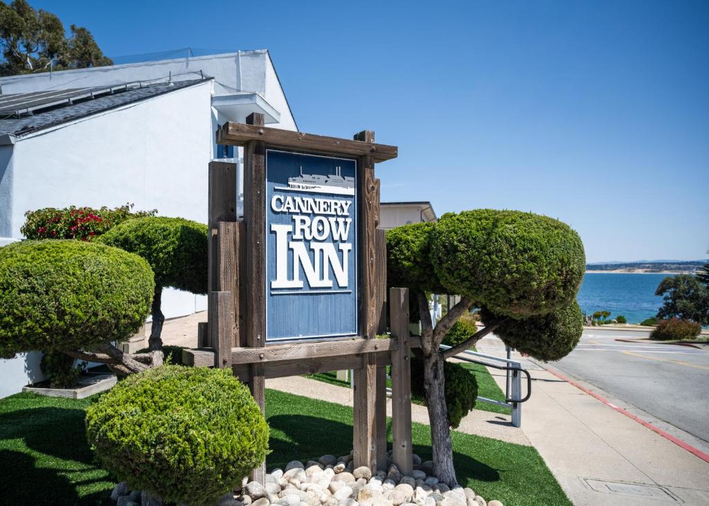 a sign for the canyon how inn with bushes at Cannery Row Inn in Monterey