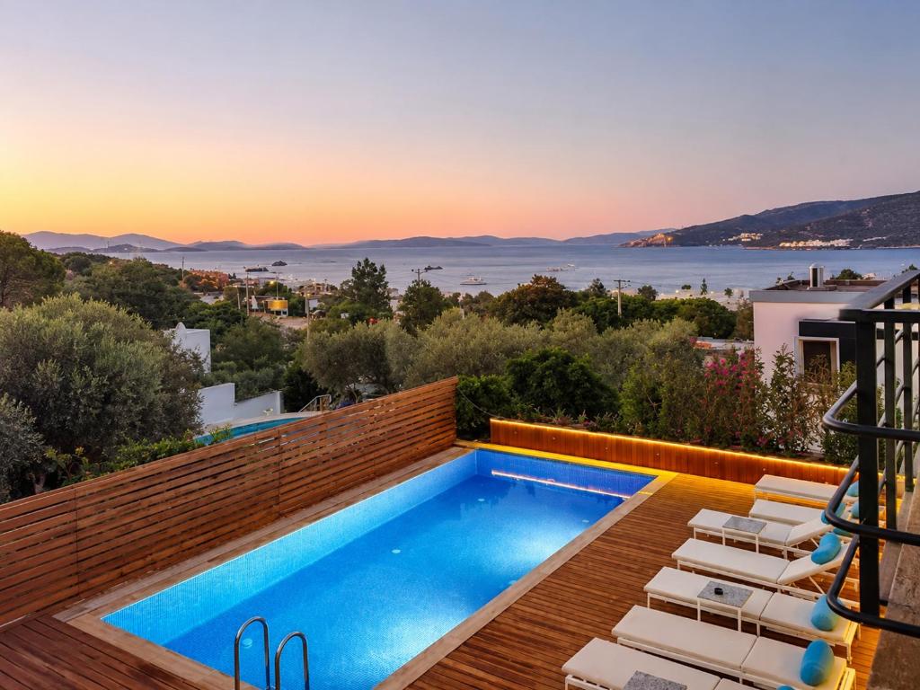 a swimming pool on the roof of a house with a view at Bodrum Blue Bay Hotel & Restaurant in Bodrum City