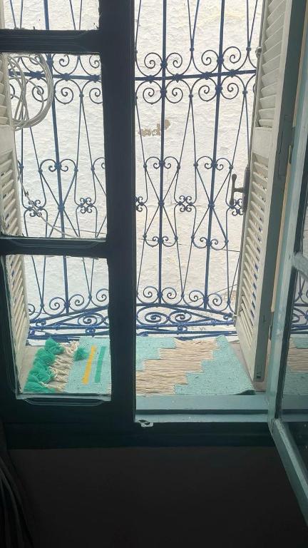 an open door to a balcony with a view of a yard at Beit Emna3 in Kairouan