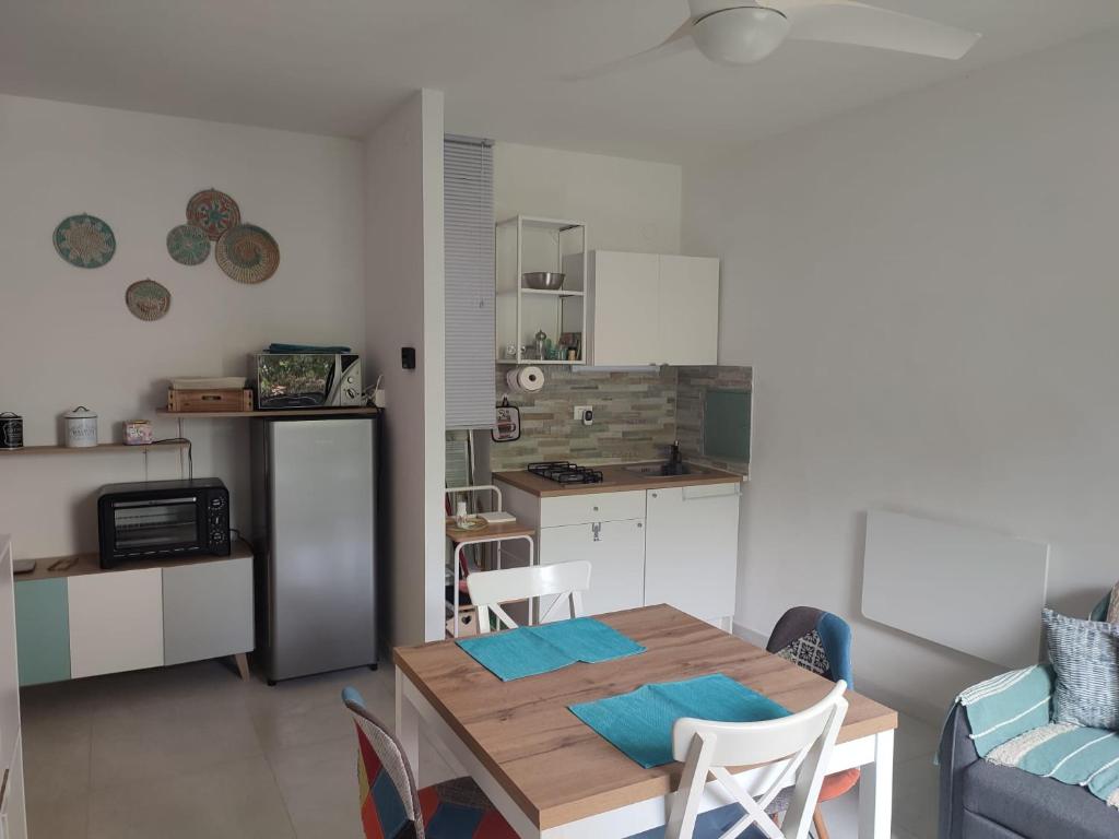 a kitchen and dining room with a table and chairs at Verde Lido in Livorno