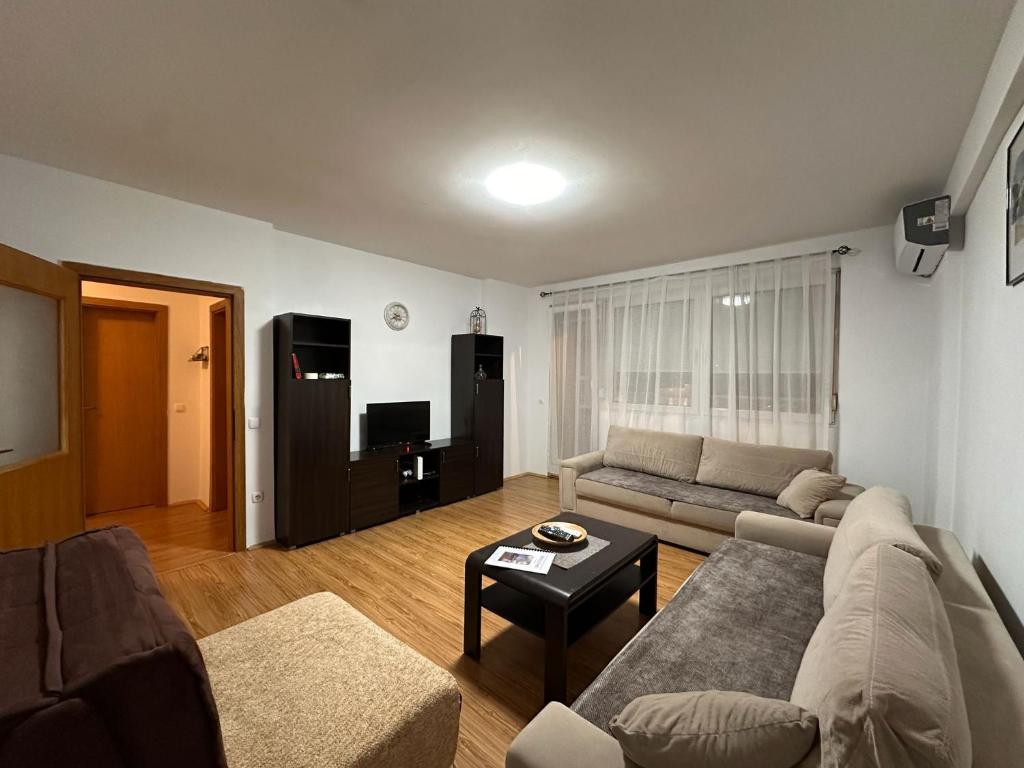 a living room with a couch and a tv at Boulevard Mitrovica in Mitrovica