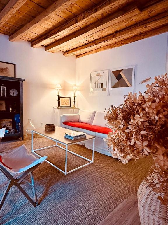 a living room with a bed and a table at ValTho Orelle Le Paradis Blanc in Orelle