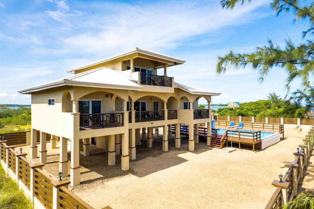 a house on the beach with a pool at Elegant Beachfront Villa Pool & Beach Family Fun in Maya Beach