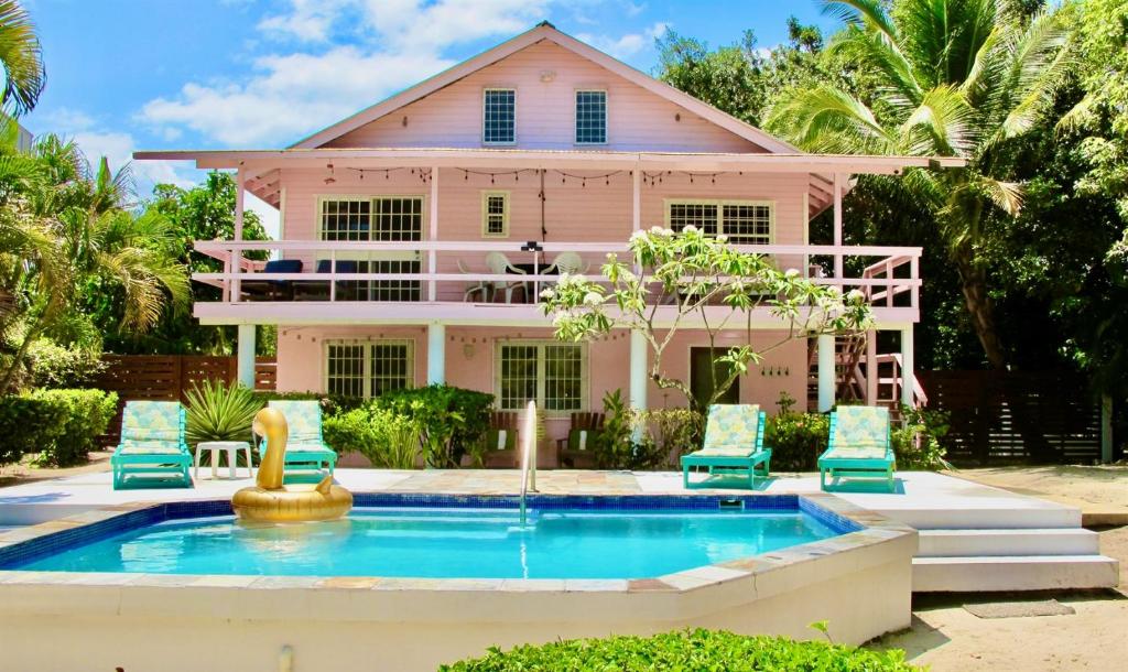 a pink house with a pool in front of it at Beachfront Bungalow-Pool & Oceanfront-Views-Golf in Seine Bight Village