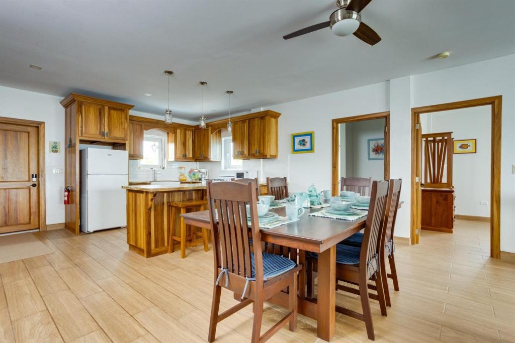 a kitchen and dining room with a table and chairs at Grand Sunset Decks Luxury Home on the Lagoon in Maya Beach