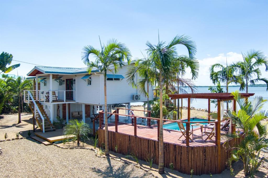 a house on the beach with a deck and a pool at Luxurious Lagoon Home w Elegant Decor & Pool in Maya Beach