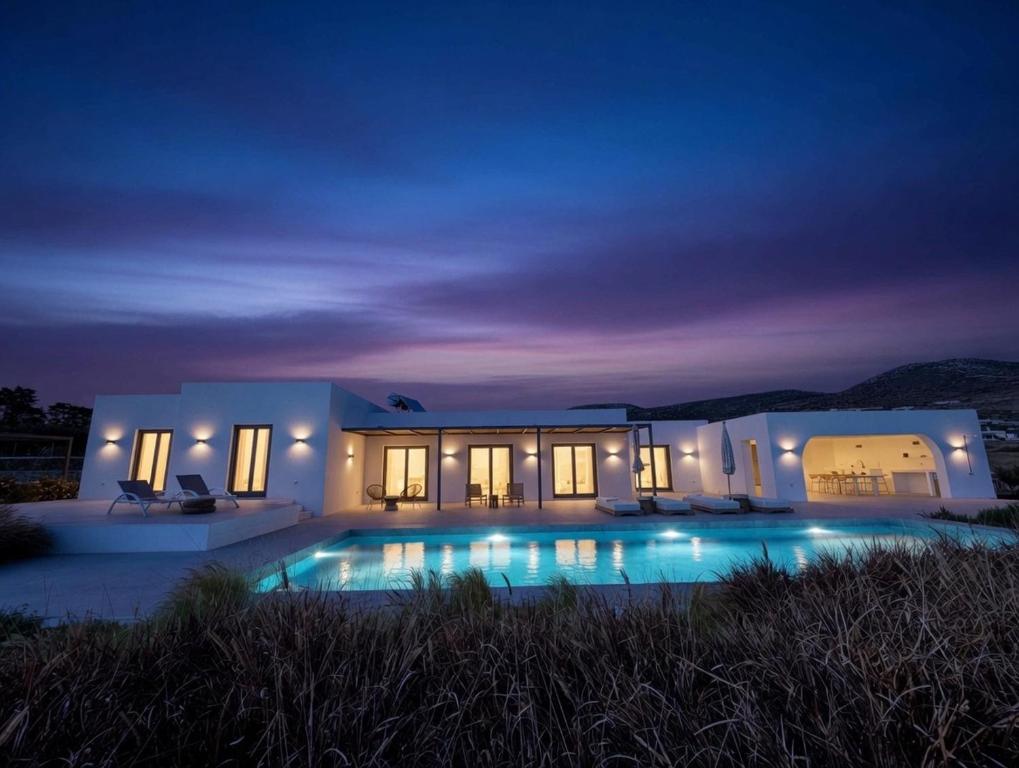 a villa with a swimming pool at night at Faragas Hill Euphoria Villa in Angairiá