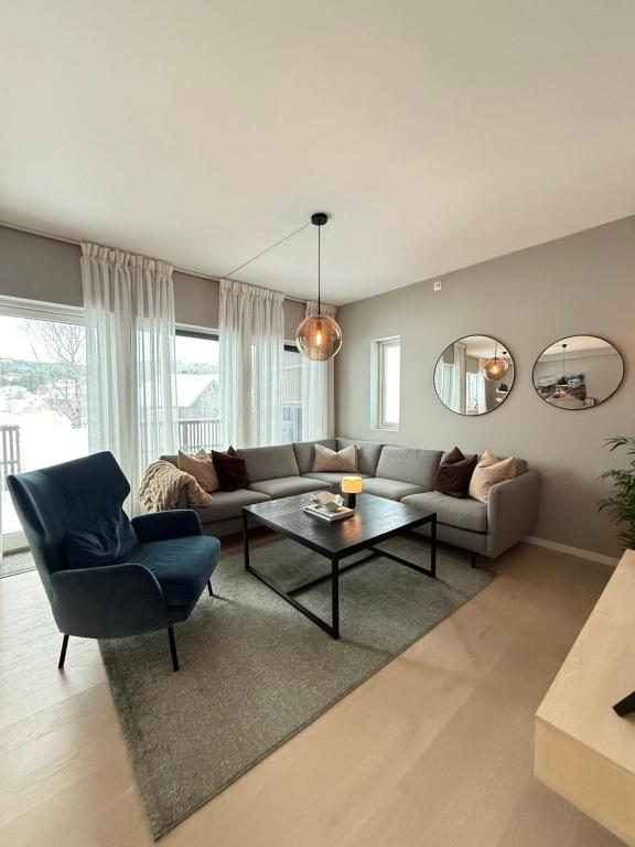 a living room with a couch and a table at Lux Apartment Gravdal in Gravdal