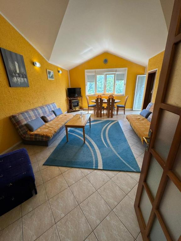 a living room with a couch and a table at Stas Apartments in Đenovići