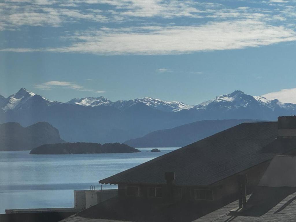 a view of a large body of water with mountains at URBANA SUITES & STUDIOS 440 in San Carlos de Bariloche