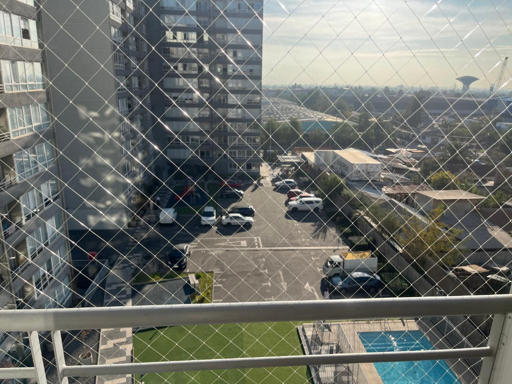 a view of a parking lot with a tall building at Plaza Cervante II in Santiago