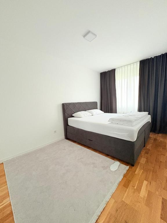 a bedroom with a bed and a rug at Sky apartment in Sarajevo