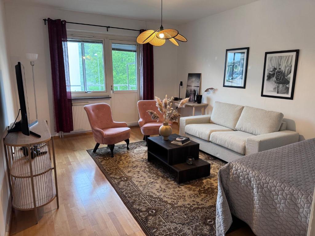 a living room with a couch and a tv at Centrumnära in Gothenburg