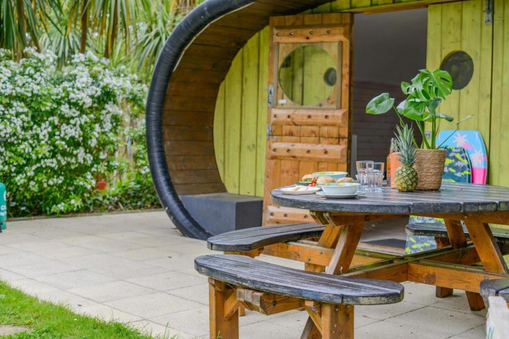 a picnic table and bench in front of a house at 1 Bed in Bude oc-s34855 in Bude