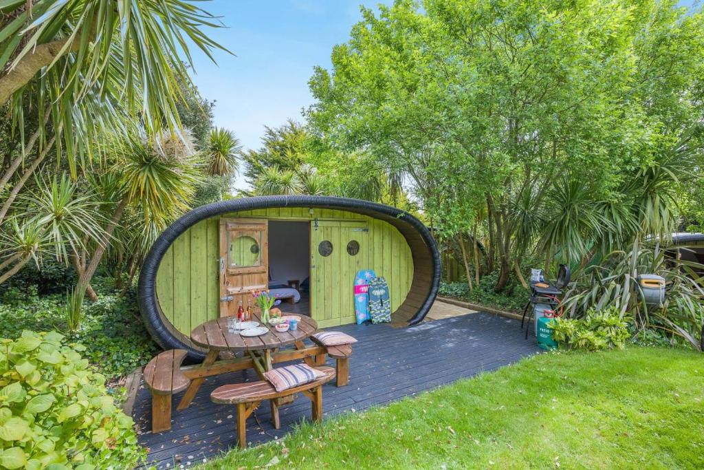 a circular shed with a table and chairs in a yard at 1 Bed in Bude oc-s34853 in Bude