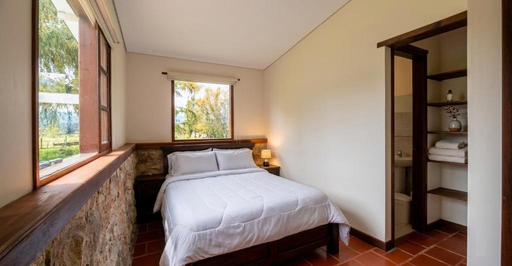 a bedroom with a bed and a window at Hotel la Mana Nobsa in Nobsa