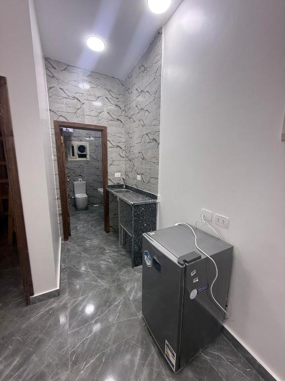 a stone bathroom with a toilet and a sink at Villa solla in Dahab