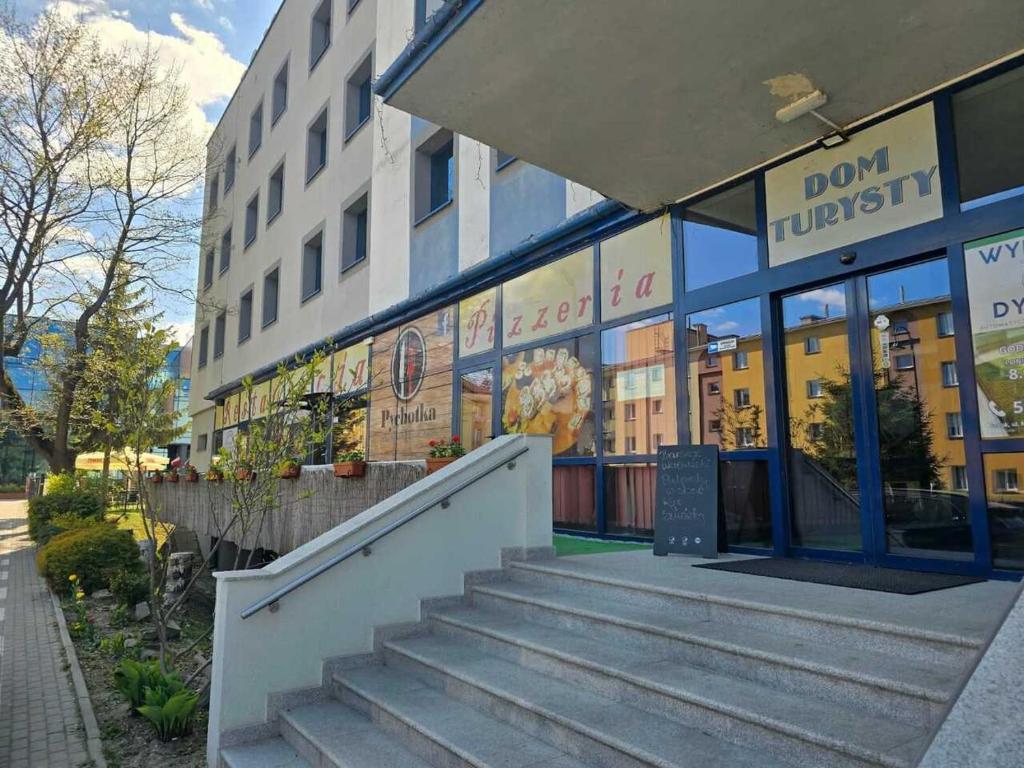 a building with stairs in front of a building at Dom Turysty Sanok in Sanok