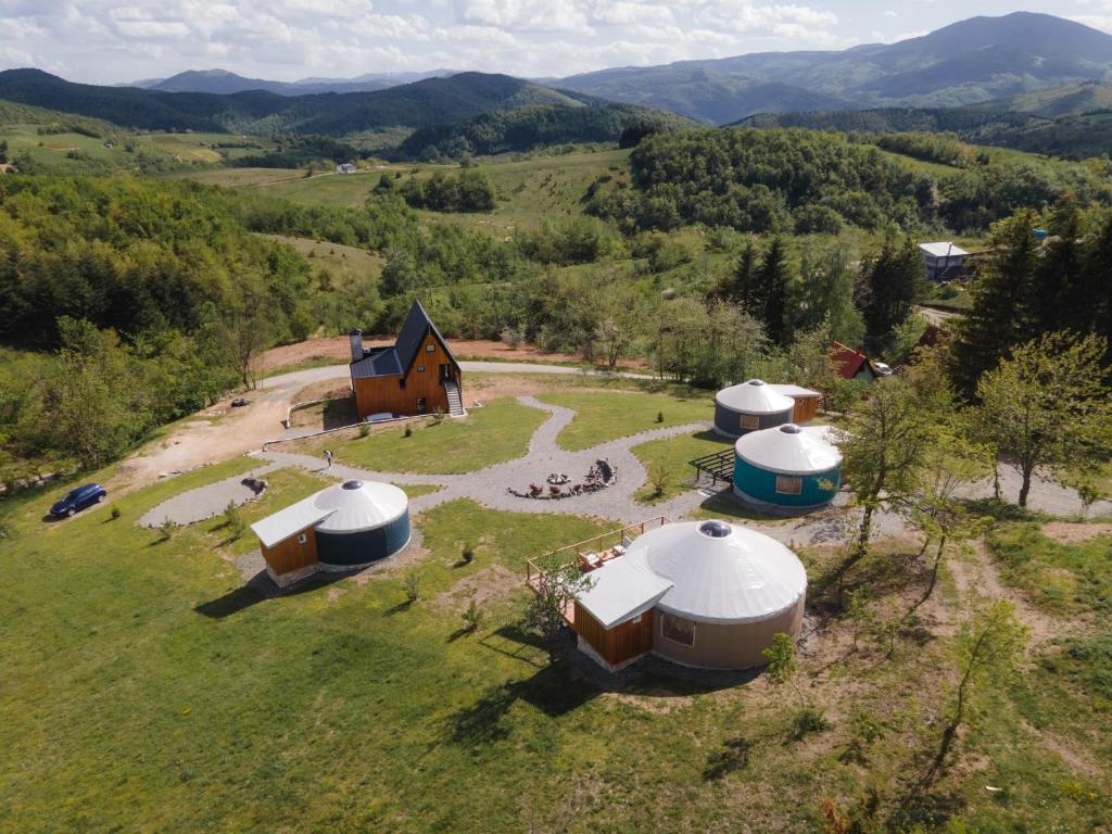 an aerial view of a farm with domes in a field at ETER Yurt Retreat in Stanišinci
