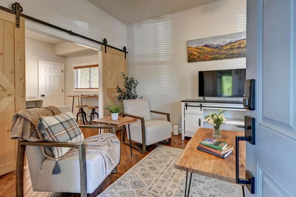 a living room with a couch and a table at Downtown - Colorado Cool - Relaxing and Quiet in Colorado Springs