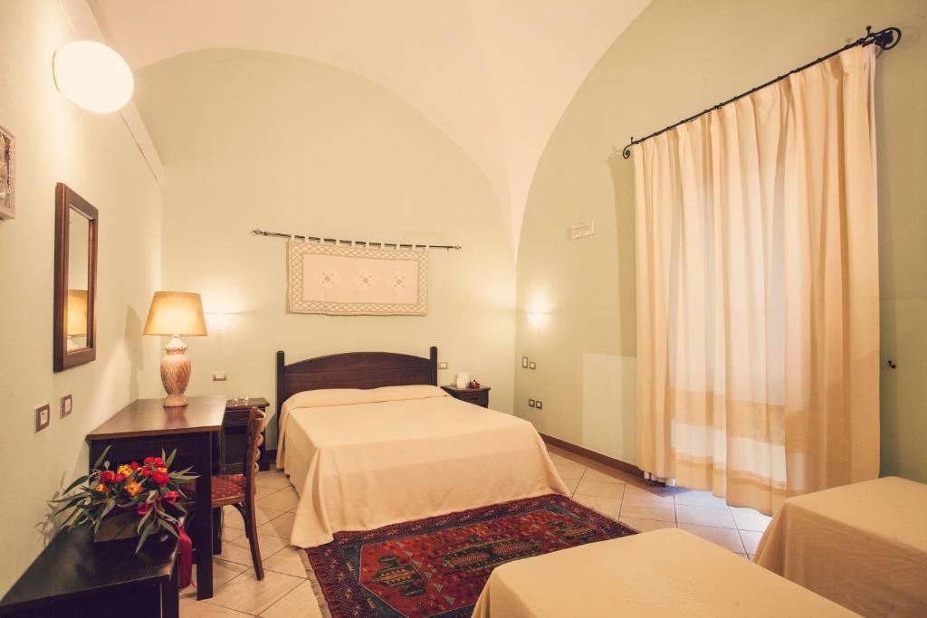 Postel nebo postele na pokoji v ubytování Hotel Il Duomo PHG