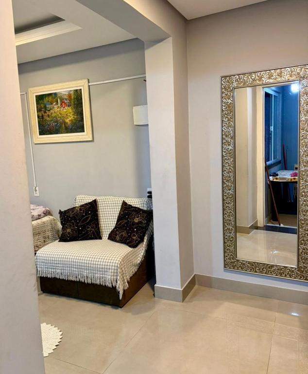 a living room with a mirror and a couch at Casa ao lado do parque Beto carreiro da de ir a pé para o parque João carlos casas in Penha