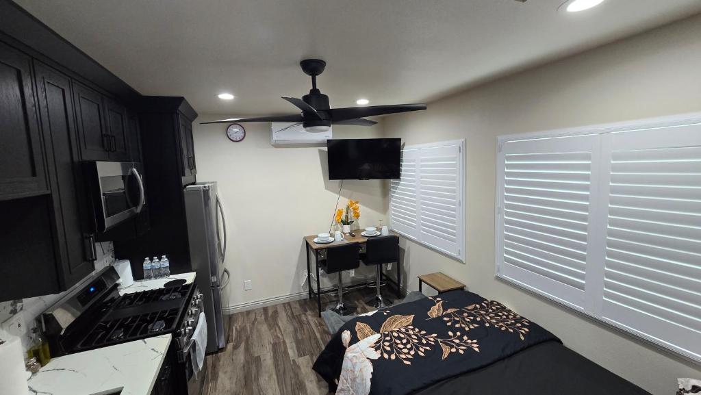 a room with a bed and a ceiling fan at Cozy Tiny Home For 2 People Studio Type in Norwalk