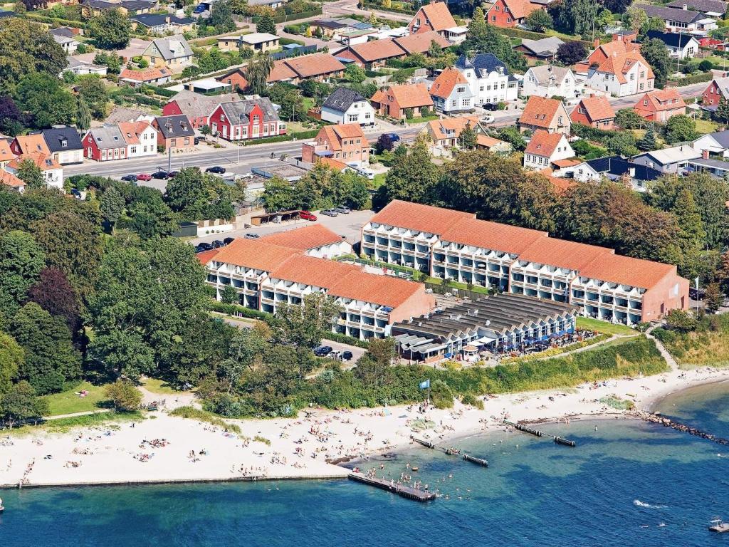 an aerial view of a resort on a beach at Home in Faaborg with swimming pool in Faaborg