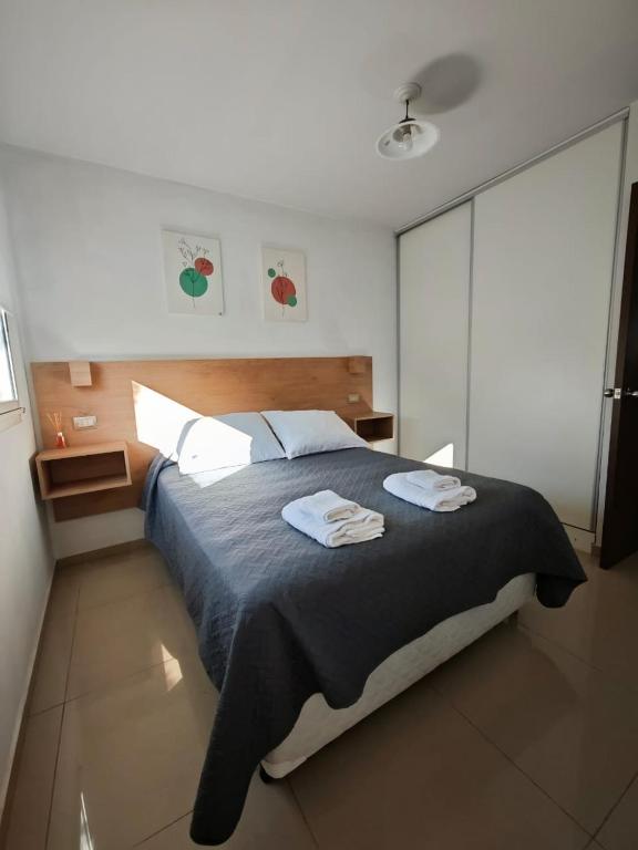 a bedroom with a bed with two towels on it at La niña in San Juan