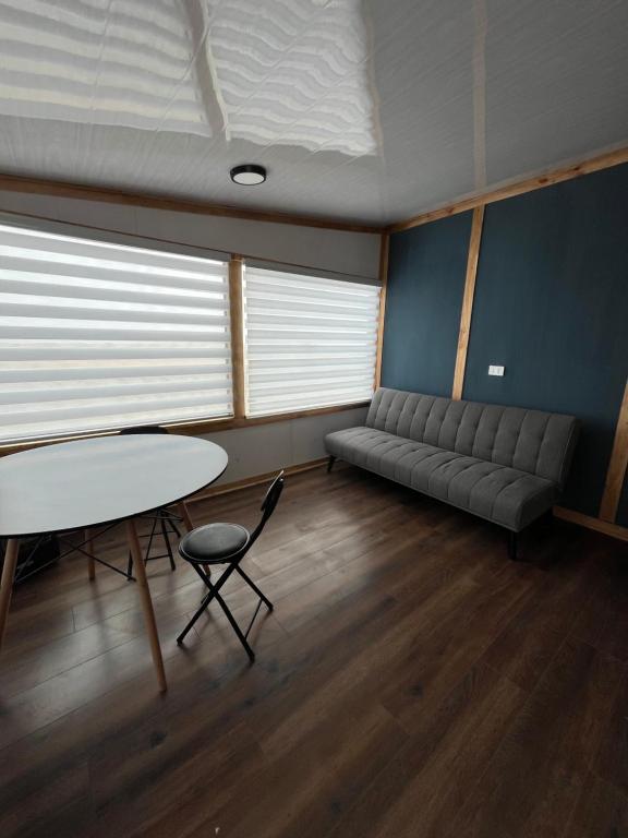 a room with a couch and a table and chair at nido de mar in Cobquecura