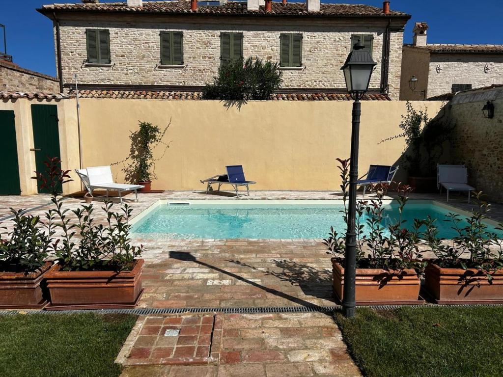 a swimming pool in front of a house at Apartment Stele, Pesaro in Pesaro