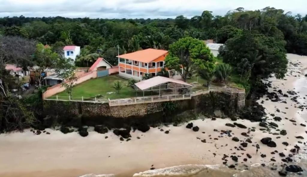 an aerial view of a house on the water at Casarão da ilha in Ilha Cotejuba