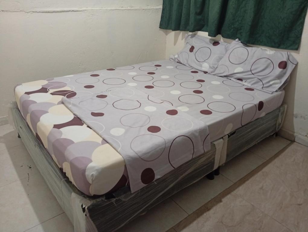 a bed with polka dots on it in a room at Casa Hotel el Sueño in Villavieja