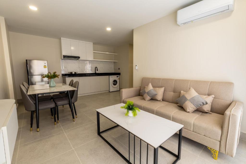a living room with a couch and a table at Walk Street Hotel & Apartment in Phnom Penh