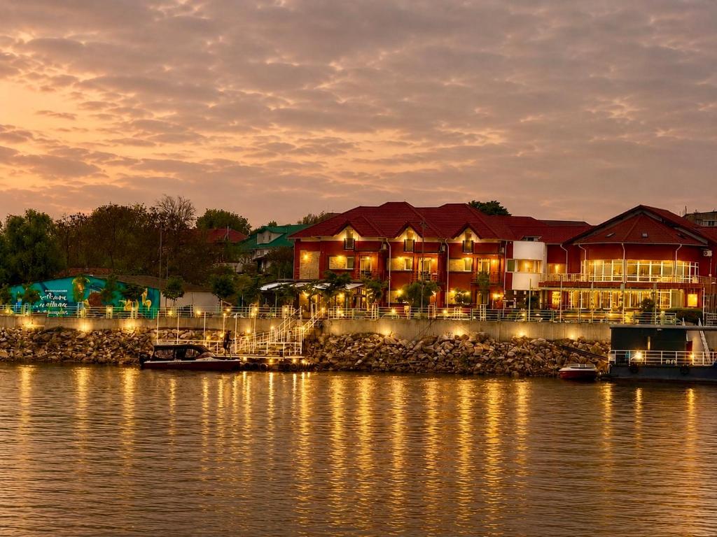 a resort on the water at night at Casa Teo in Mahmudia