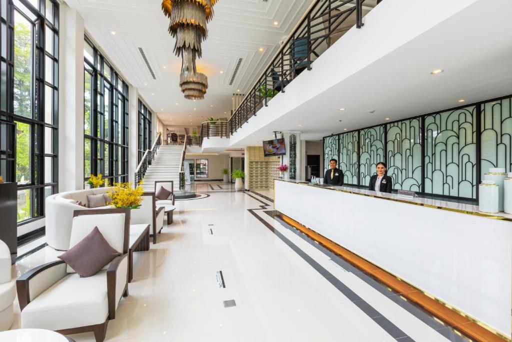 a lobby of a building with windows and a bar at Kantary Hotel Banchang in Ban Chang
