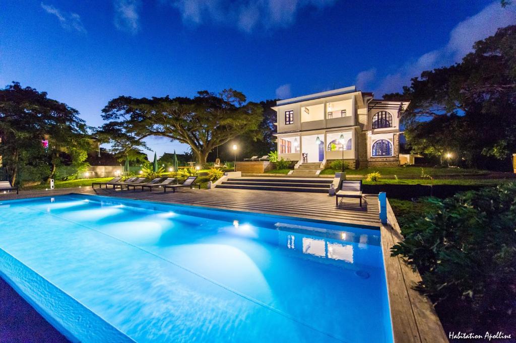 a large swimming pool in front of a house at Apolline in Fort-de-France